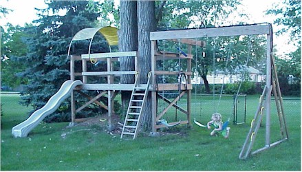 My daughter Morgen on the swing set I built